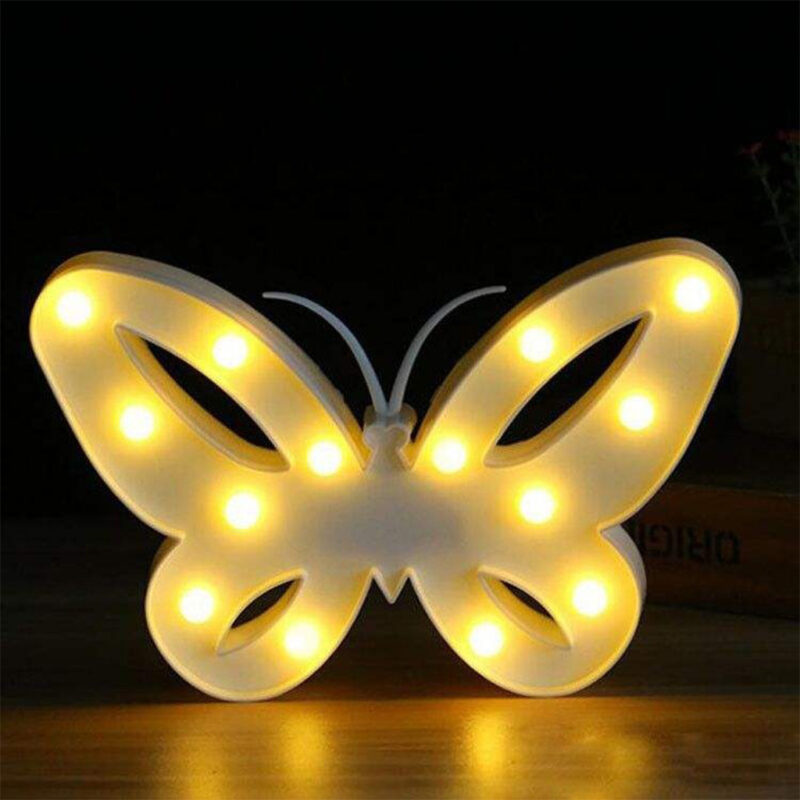 A white LED Butterfly Party Light with warm yellow lights illuminated, creating a soft glow on a dark background.