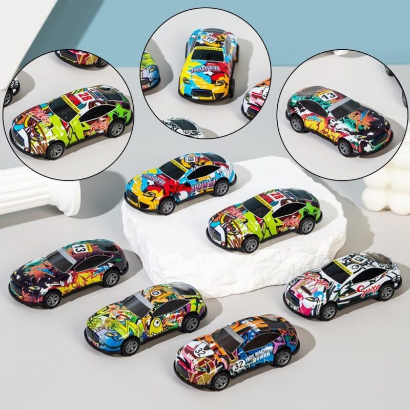 A collection of various pull back metal car toys with different colorful graffiti designs displayed on a white surface.