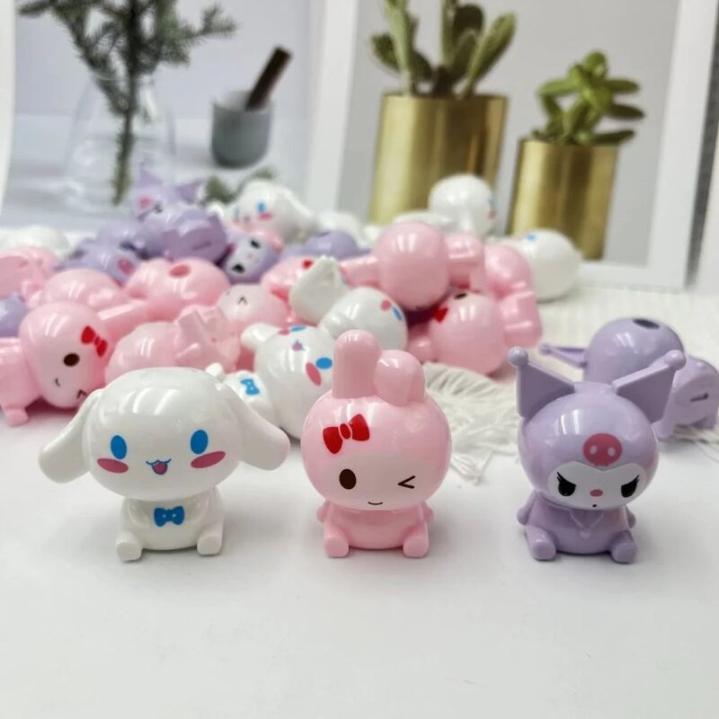 A collection of small, cute Sanrio Character Point Pencil Sharpeners featuring My Melody (pink bunny), Cinnamoroll (white puppy), and Kuromi (purple imp).