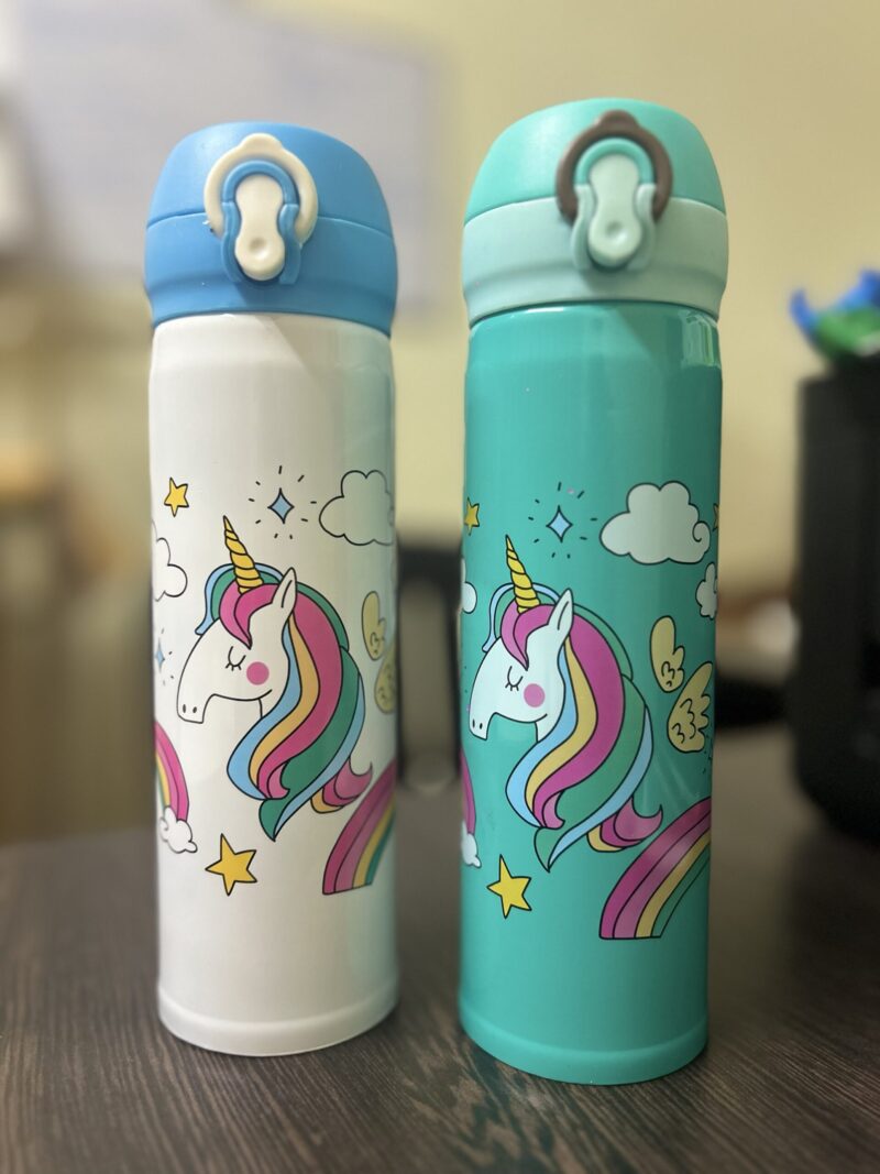Unicorn Insulated Water Bottle. Two Unicorn Stainless Steel Vacuum Insulated Water Bottles, one white and one green, each featuring a unicorn illustration with a rainbow mane, stars, and clouds.