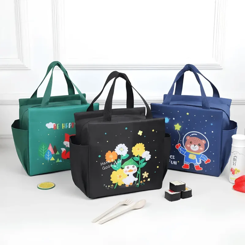Three Big Insulated Lunch Bags in green (fox), black (duck with flowers), and dark blue (astronaut), displayed on a white surface with food items.